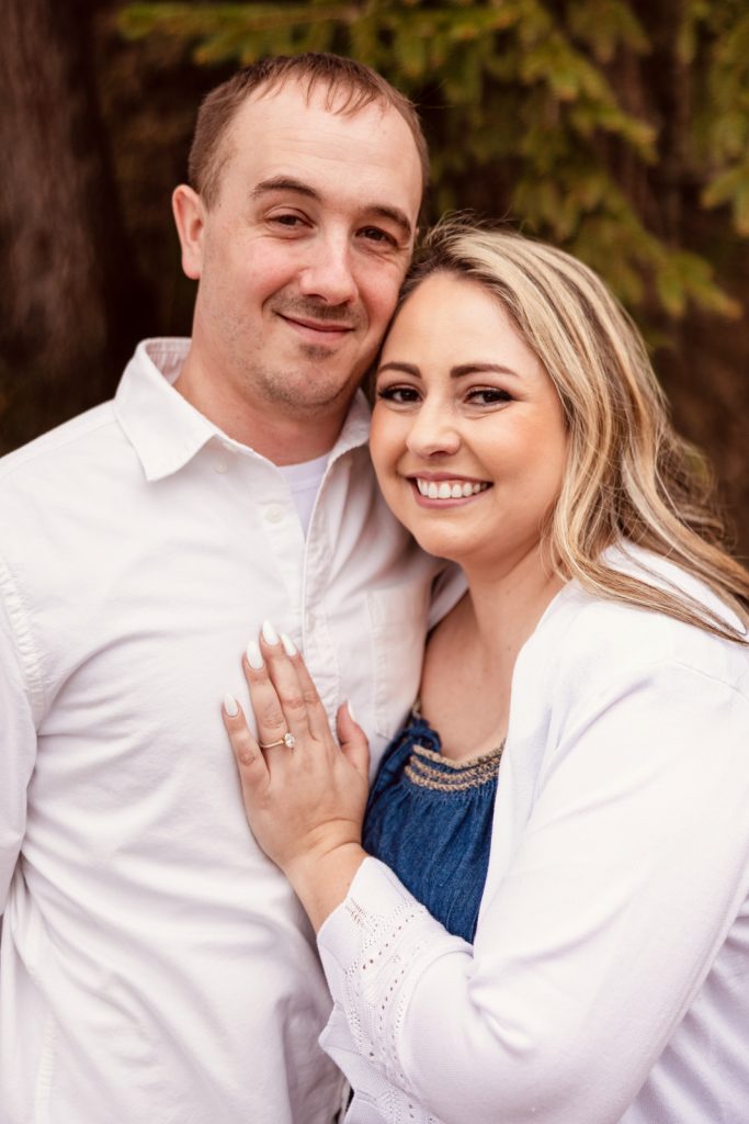 Bianca and Nick smiling together during their engagement session in Hayward, WI, showcasing love and connection.