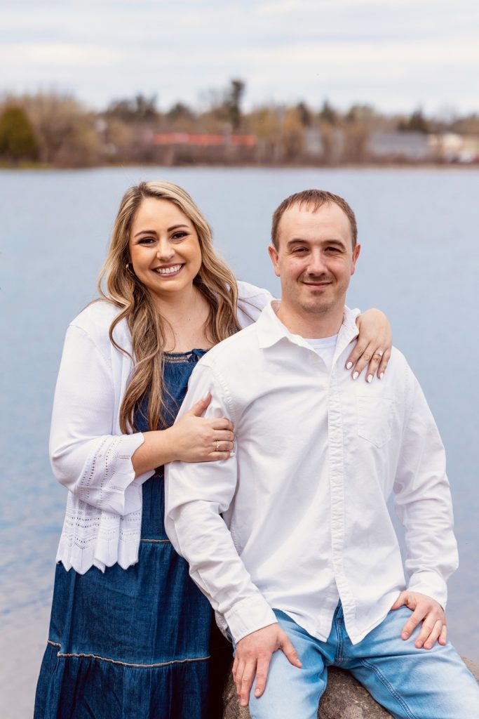 Bianca and Nick posing together by the water in Hayward, WI, during their engagement session, showcasing love and connection.