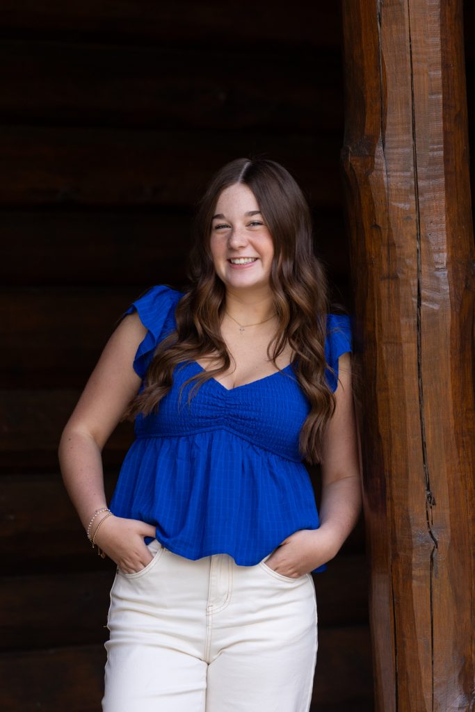 Julia's senior portrait in Hayward, WI, showcasing a bright blue top and natural smile.