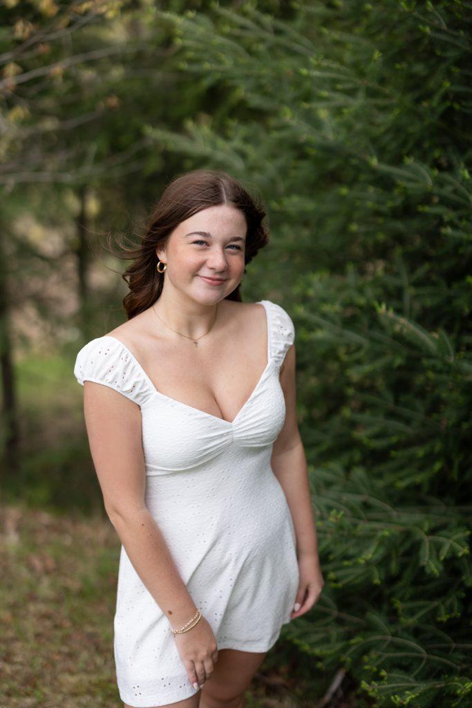 Julia's senior portrait in white dress, Hayward Wisconsin, showcasing senior photography session.