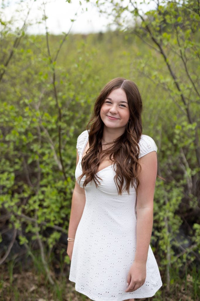 Julia's senior portrait in Hayward, WI, showcasing natural light and a white dress.