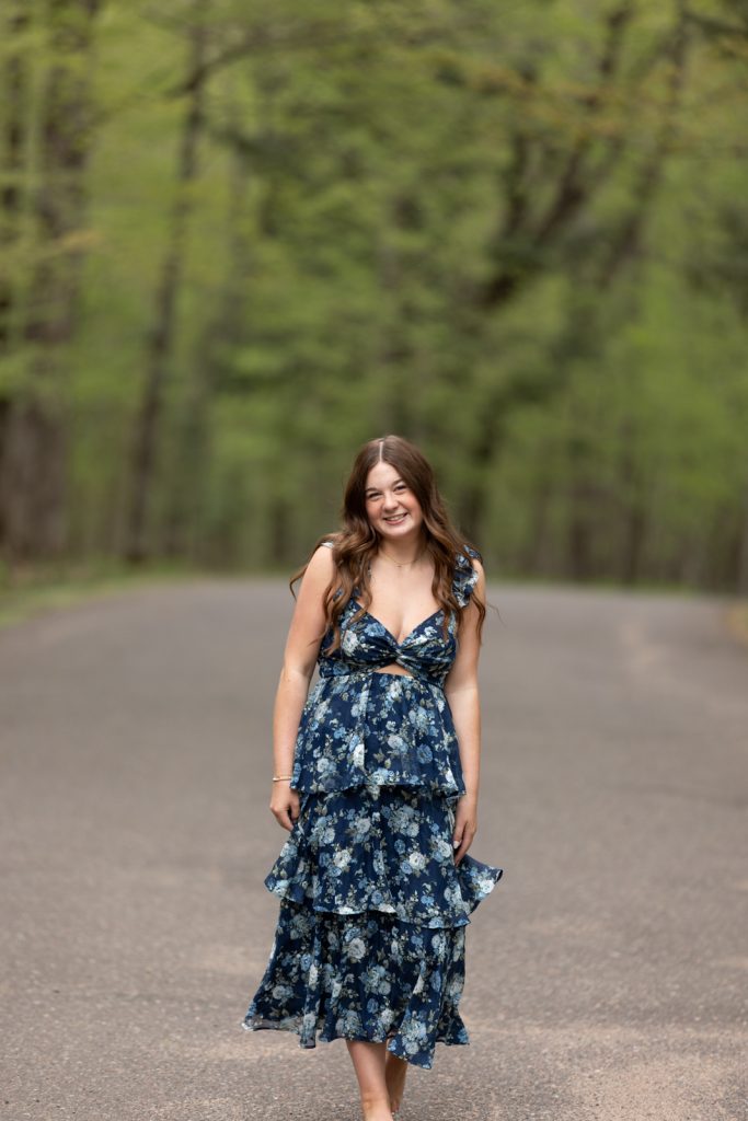 Julia's senior portrait in floral dress, Hayward WI, showcasing senior photography services.