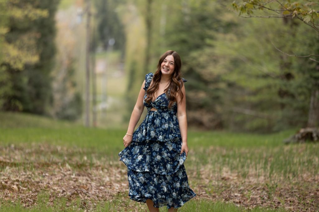 Julia's senior portrait session in Hayward, Wisconsin, showcasing a smiling young woman in a floral