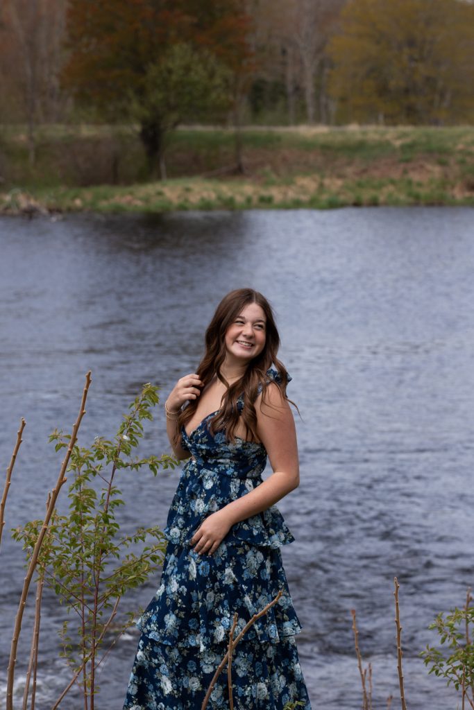 Julia's senior portrait session in Hayward, WI, featuring a smiling young woman in a blue