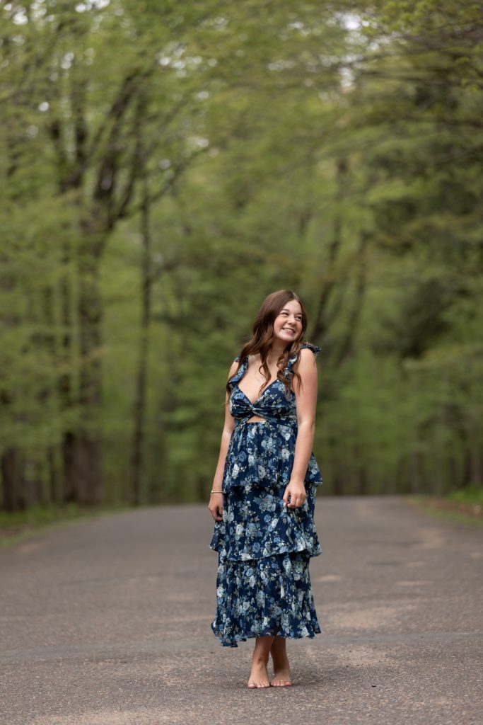 Julia's senior portrait session in Hayward, WI, showcasing a smiling young woman in a floral