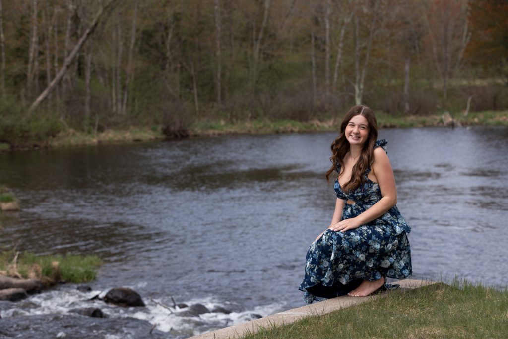 Julia's senior portrait session in Hayward, Wisconsin, featuring a young woman in a floral dress