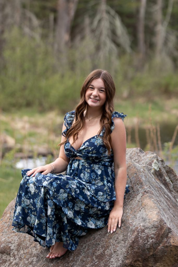Julia's senior portrait session in Hayward, WI, showcasing a smiling young woman in a floral