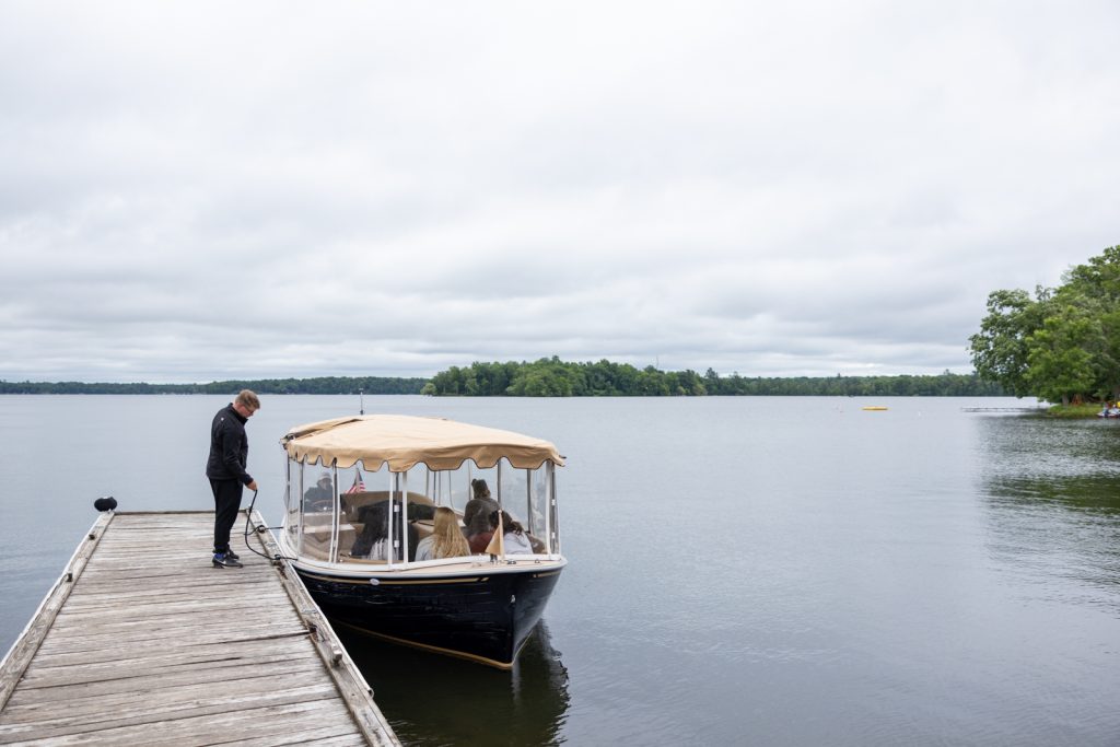 Stout’s Island boat transfer on Red Cedar Lake, Wisconsin wedding photography.