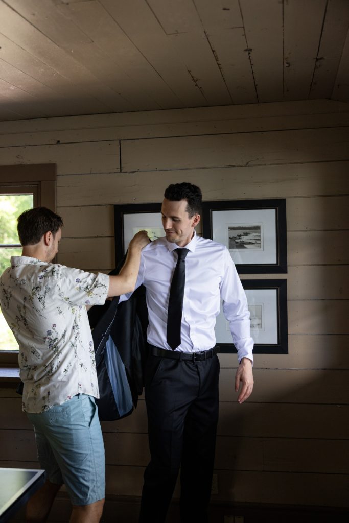 Brittany and Cole’s Stout’s Island wedding: Groom getting ready in a turn-of-the-century resort setting.