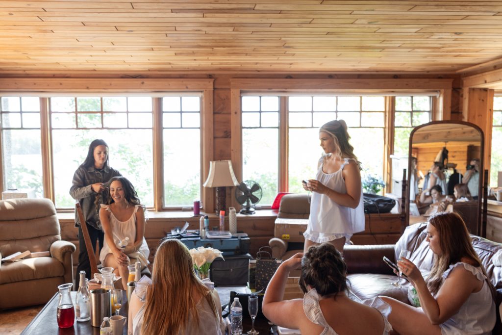 Bride and bridesmaids preparing at Stout’s Island Lodge, Wisconsin wedding venue.