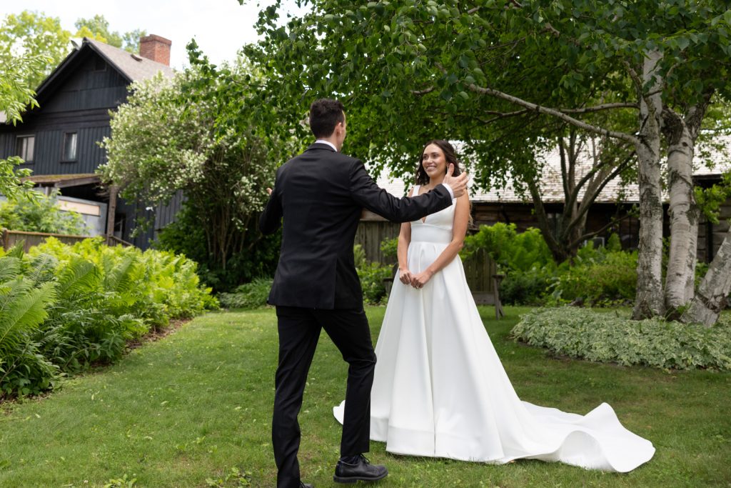 Brittany and Cole at their Stout’s Island wedding, first look among trees and greenery.