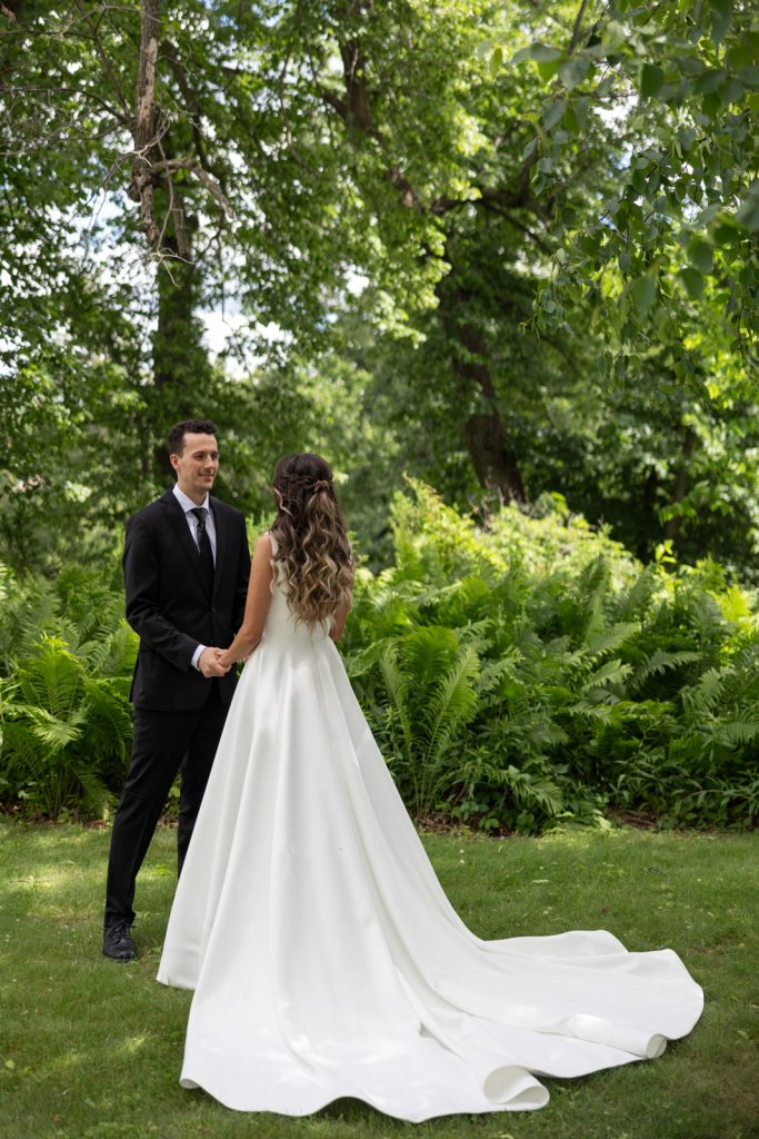 Brittany and Cole holding hands on Stout’s Island in Birchwood, Wisconsin, wedding photography.