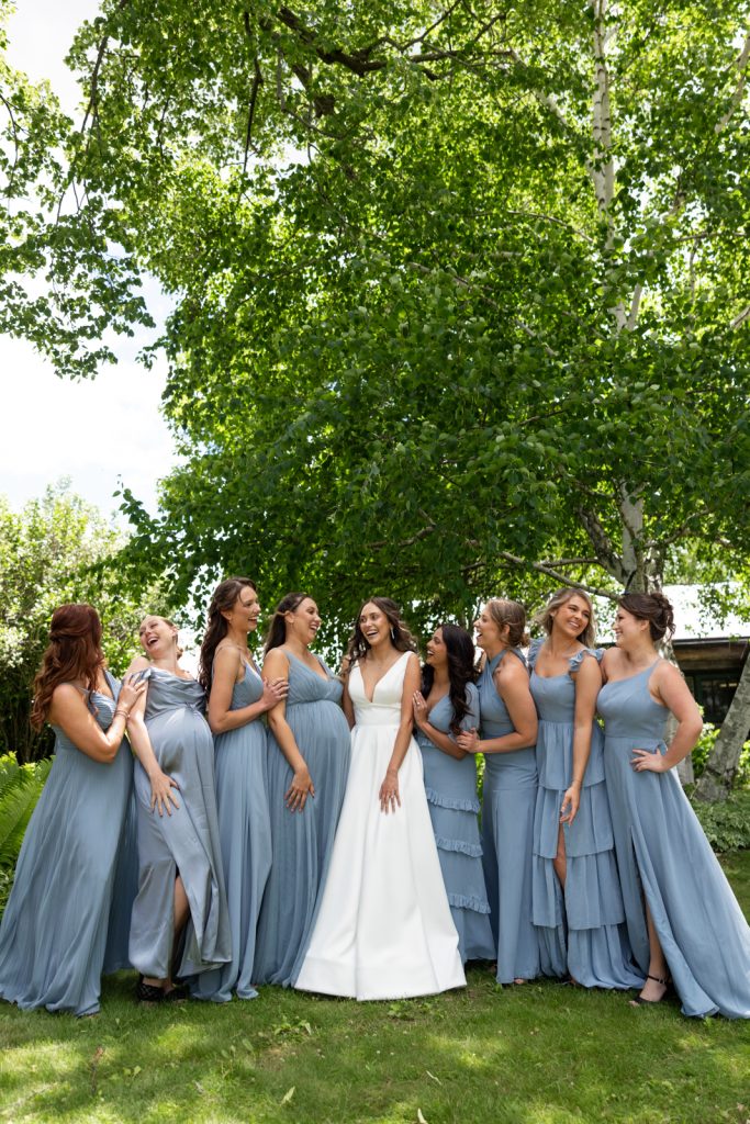 Brittany the bride with her bridesmaids in blue dresses at Stout’s Island wedding in Wisconsin.