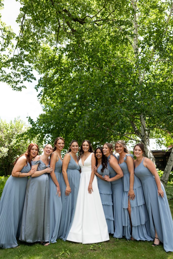 Brittany the bride and bridesmaids in blue dresses at Stout’s Island wedding in Wisconsin.