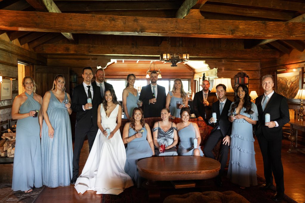 Brittany and Cole's Stout’s Island wedding party posing in the boat house lodge on Red