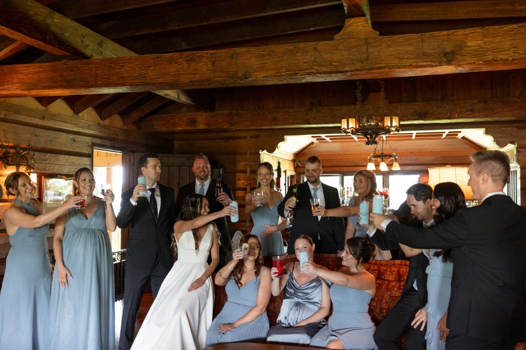 Brittany and Cole's wedding party toasting at Stout’s Island Lodge, Birchwood, Wisconsin.