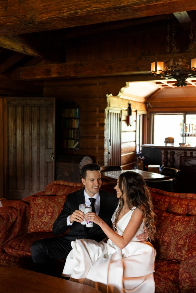 Brittany and Cole, the wedding couple, relaxing on a vintage couch at Stout’s Island Lodge