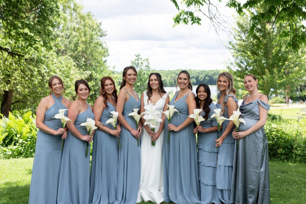 Bride and bridesmaids in blue dresses with white lilies on Stout’s Island, Wisconsin.