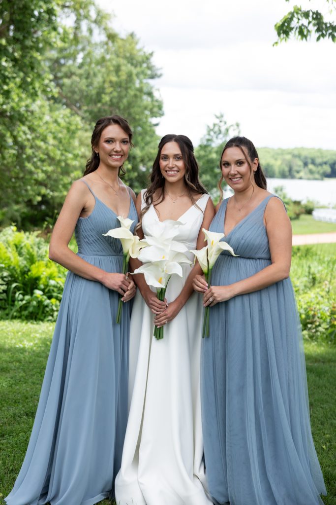 Bride and bridesmaids posing with calla lilies at Stout’s Island wedding in Wisconsin.