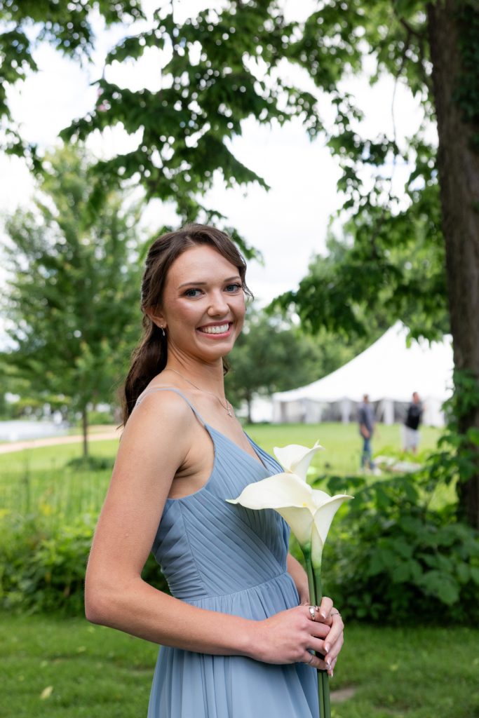 Bride holding white calla lilies at Stout’s Island wedding in Birchwood, Wisconsin.