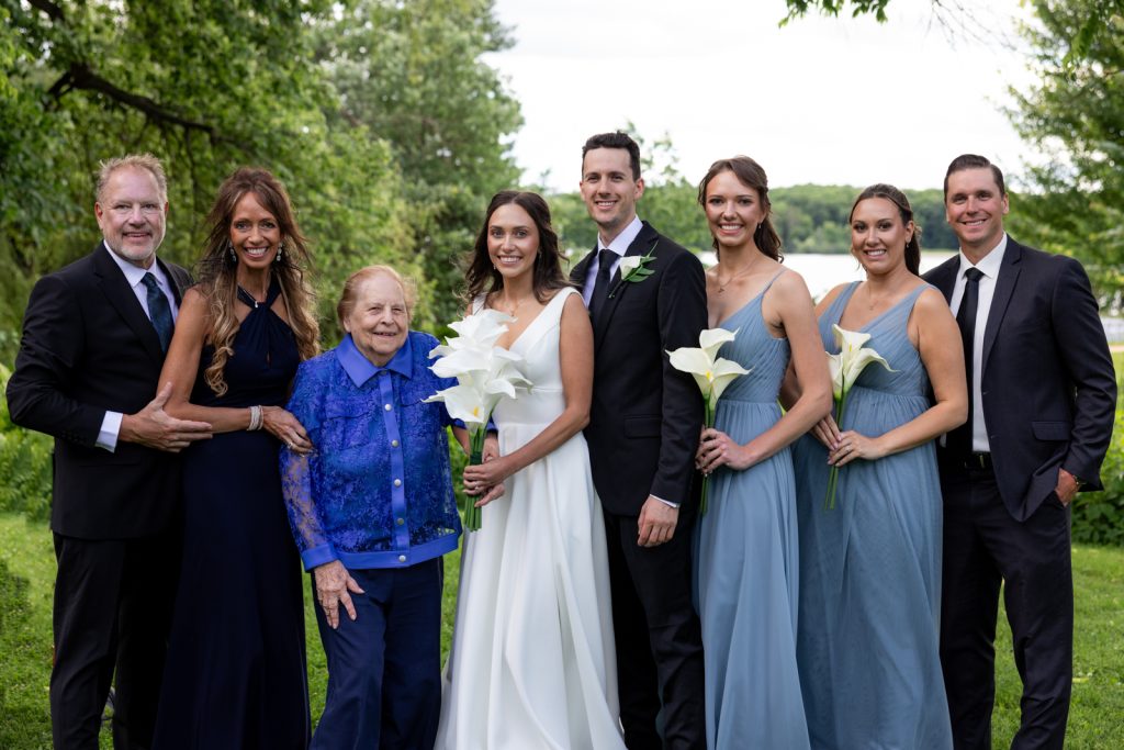 Brittany and Cole's Stout’s Island wedding party and family portrait by Red Cedar Lake, Wisconsin.