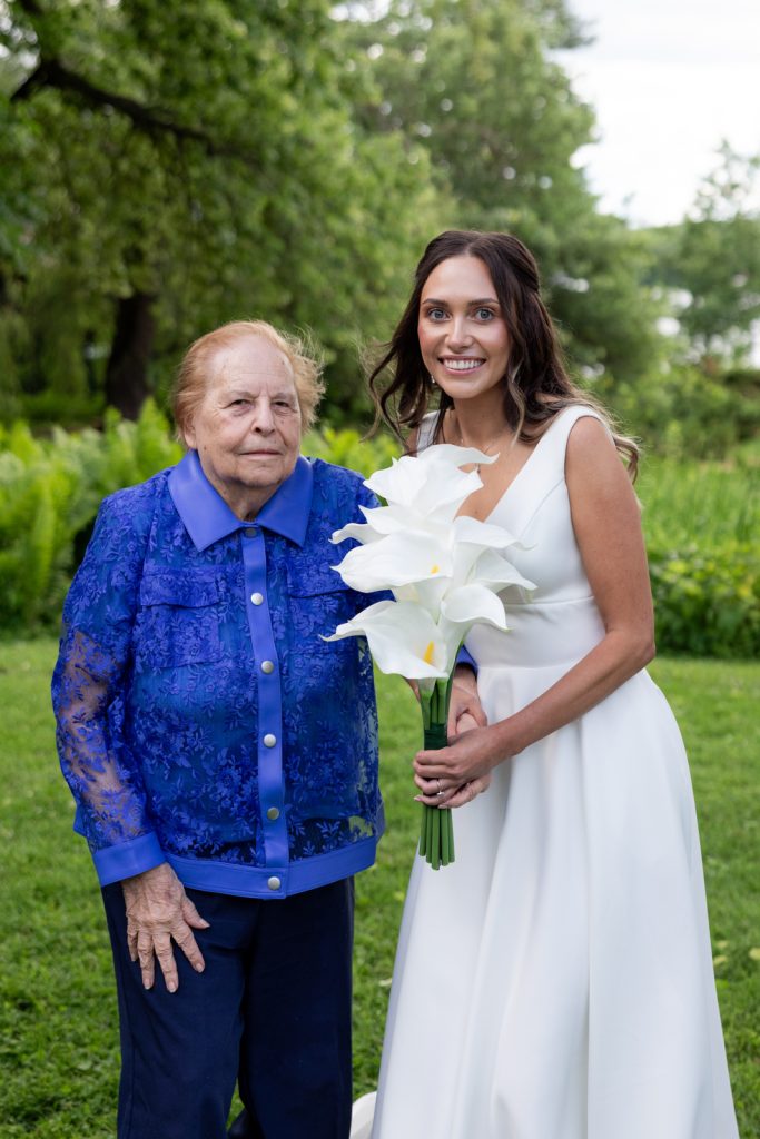Brittany in wedding dress with grandmother and calla lilies at Stout’s Island wedding in Wisconsin.
