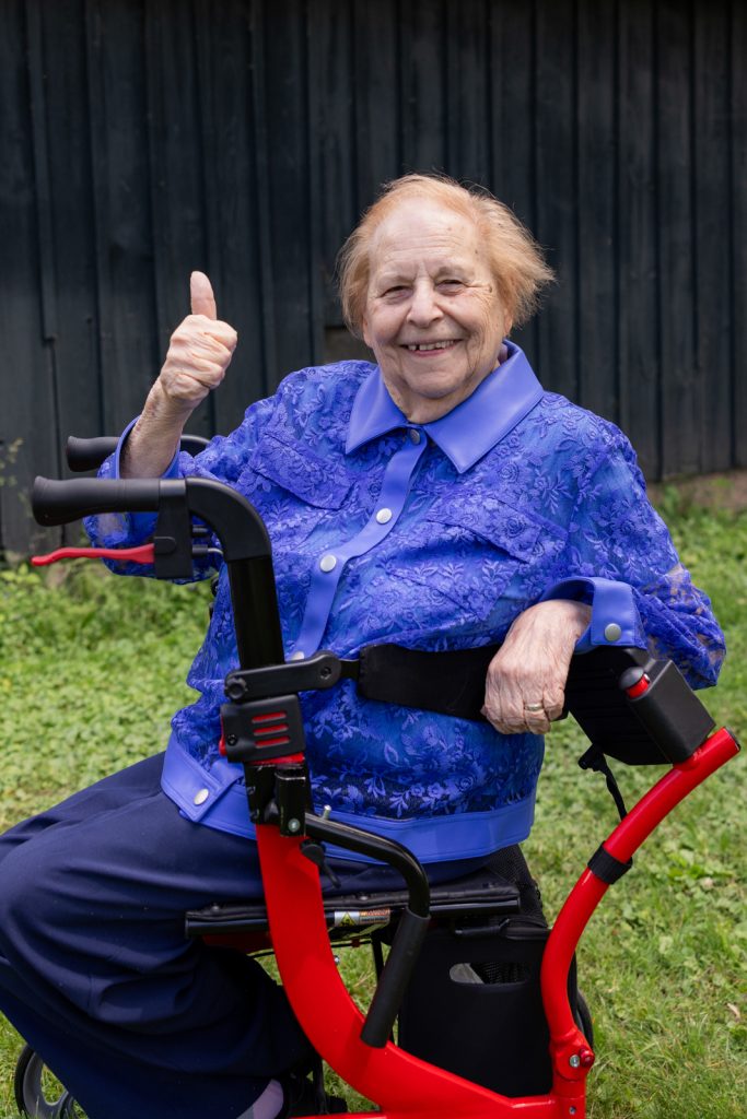 Bride on wheelchair giving thumbs up at Stout’s Island wedding in Birchwood, Wisconsin.
