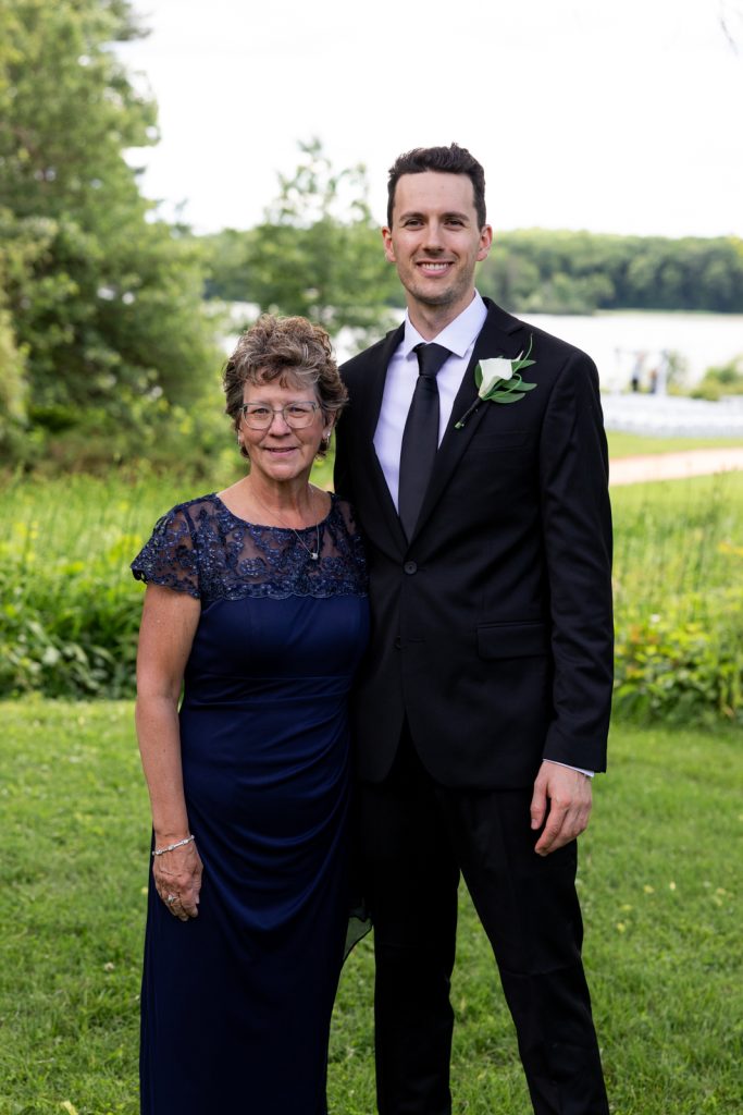 Brittany and Cole’s Stout’s Island wedding: Groom with his mother on Red Cedar Lake.
