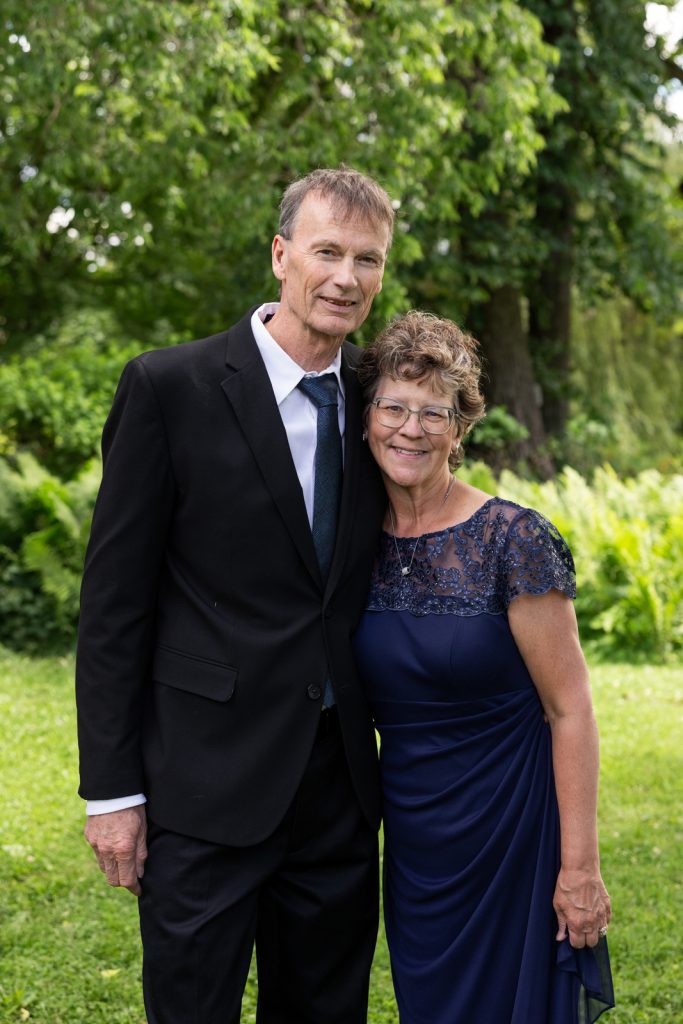 Couple posing at Stout’s Island wedding in Birchwood, Wisconsin and Red Cedar Lake