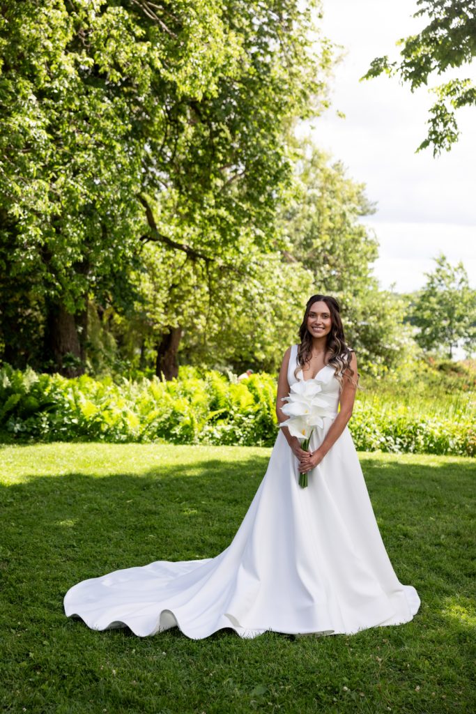 Bride in white gown and bouquet on Stout’s Island, Wisconsin wedding.