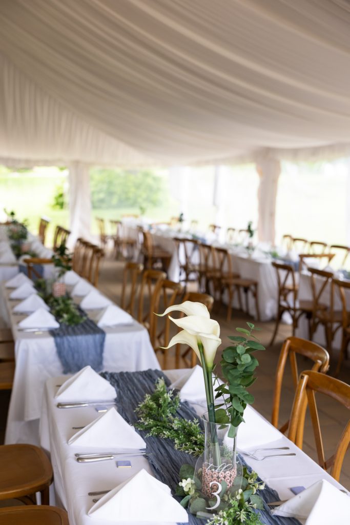 Stout’s Island wedding reception with long tables and floral arrangements in Birchwood, Wisconsin.