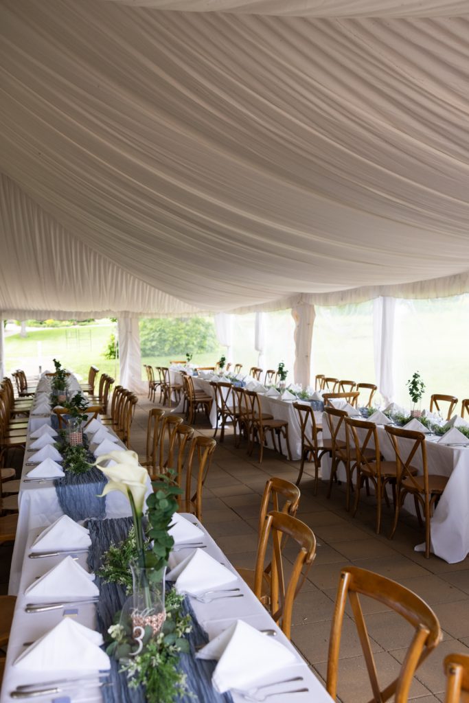 Stout’s Island wedding reception tent with long tables and chairs set for a wedding in