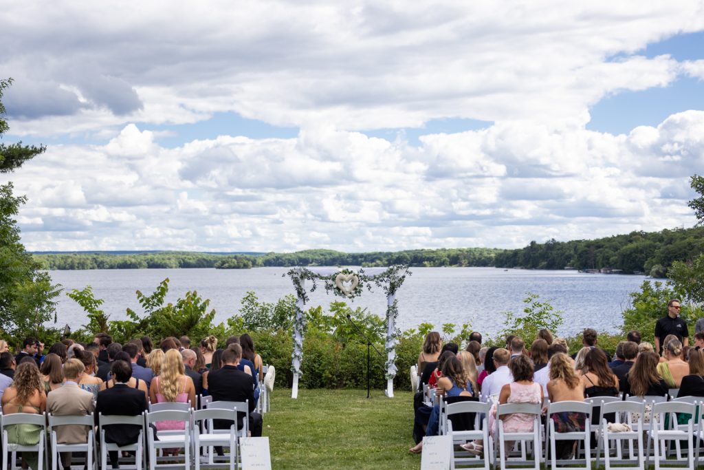 Stout’s Island wedding ceremony overlooking Red Cedar Lake and a floral archway.