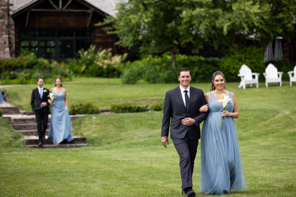 Brittany and Cole wedding party walking on Stout’s Island lawn, Birchwood, Wisconsin.