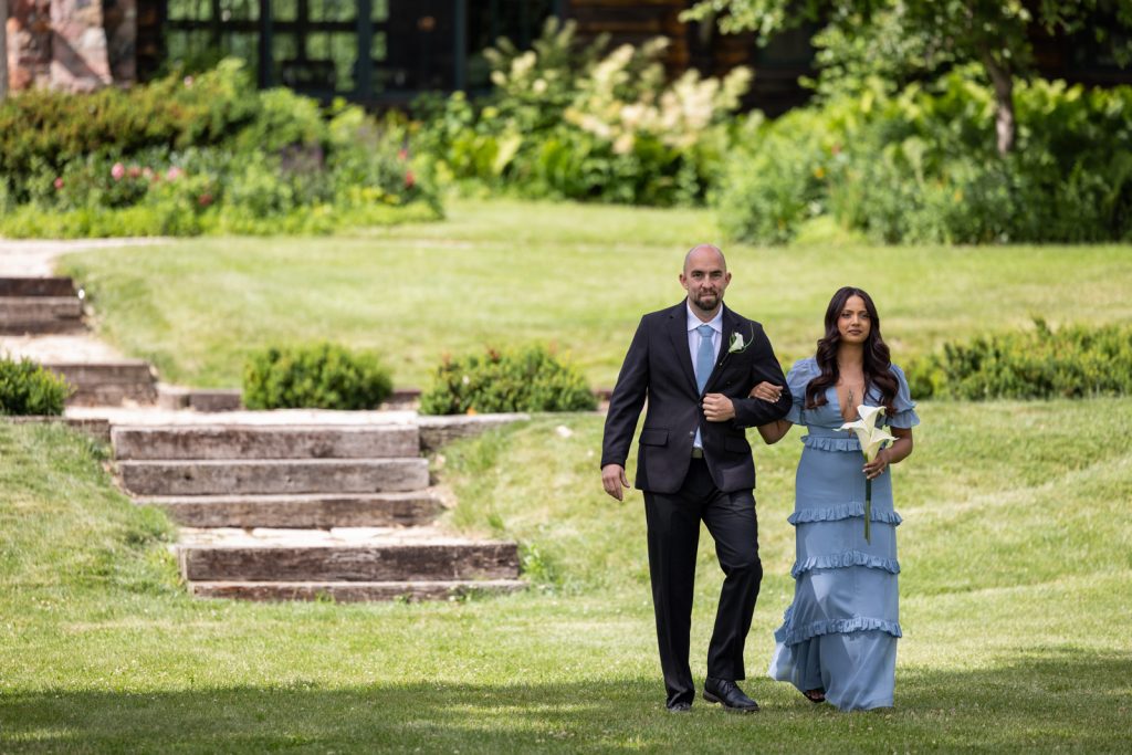 Brittany and Cole walking down stairs at Stout’s Island wedding in Birchwood, Wisconsin.