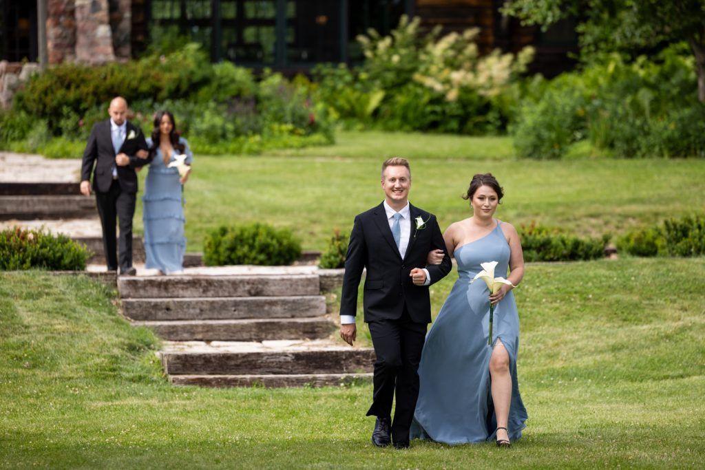 Brittany and Cole wedding party walking stairs at Stout’s Island Lodge in Wisconsin