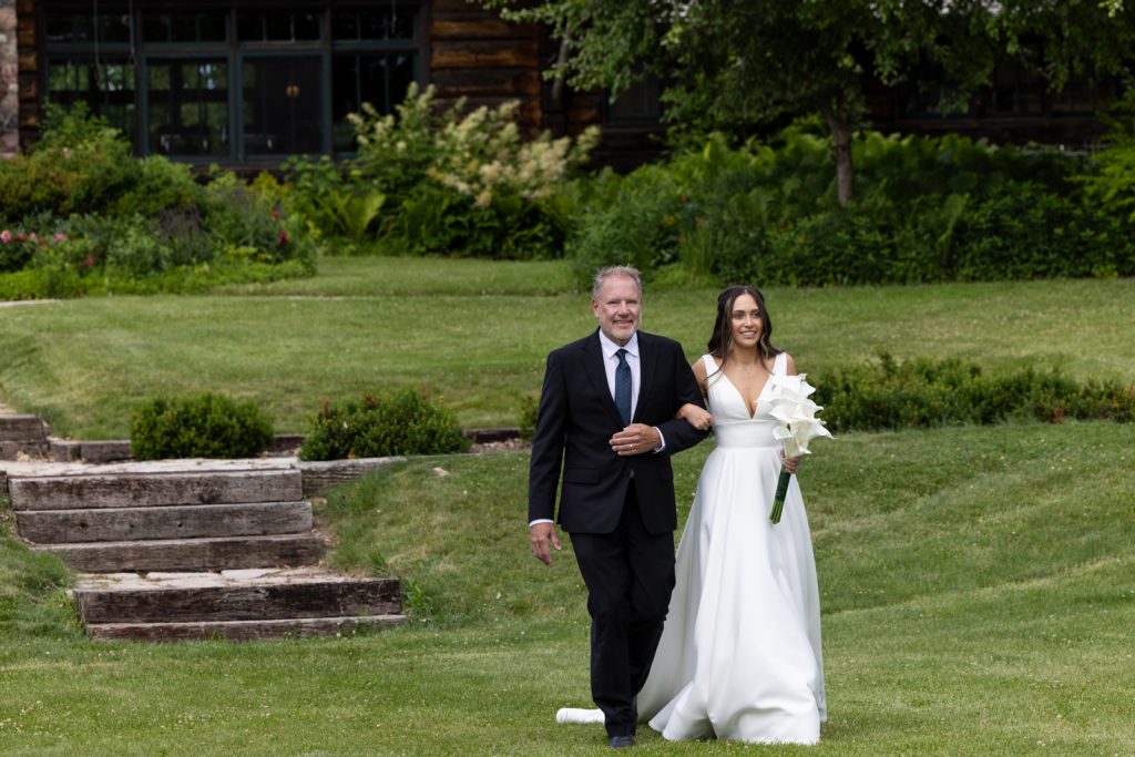 Bride and groom walking on Stout’s Island, Birchwood Wisconsin wedding ceremony.