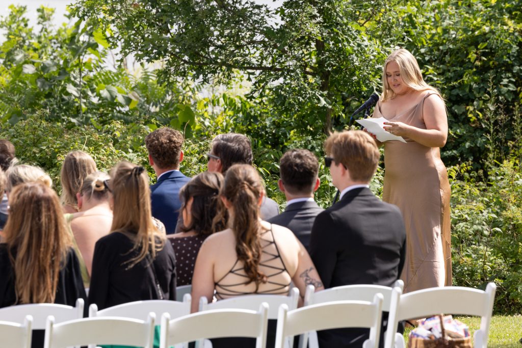 Woman reading vows at Stout’s Island wedding ceremony and reception.