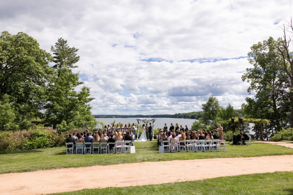 Brittany and Cole's wedding ceremony on Stout’s Island, Red Cedar Lake, Wisconsin, with guests seated
