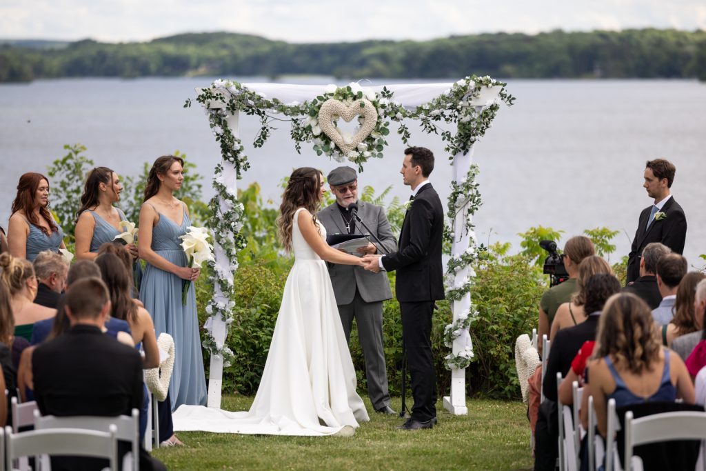 Brittany and Cole's wedding ceremony at Stout’s Island on Red Cedar Lake, Wisconsin, with floral
