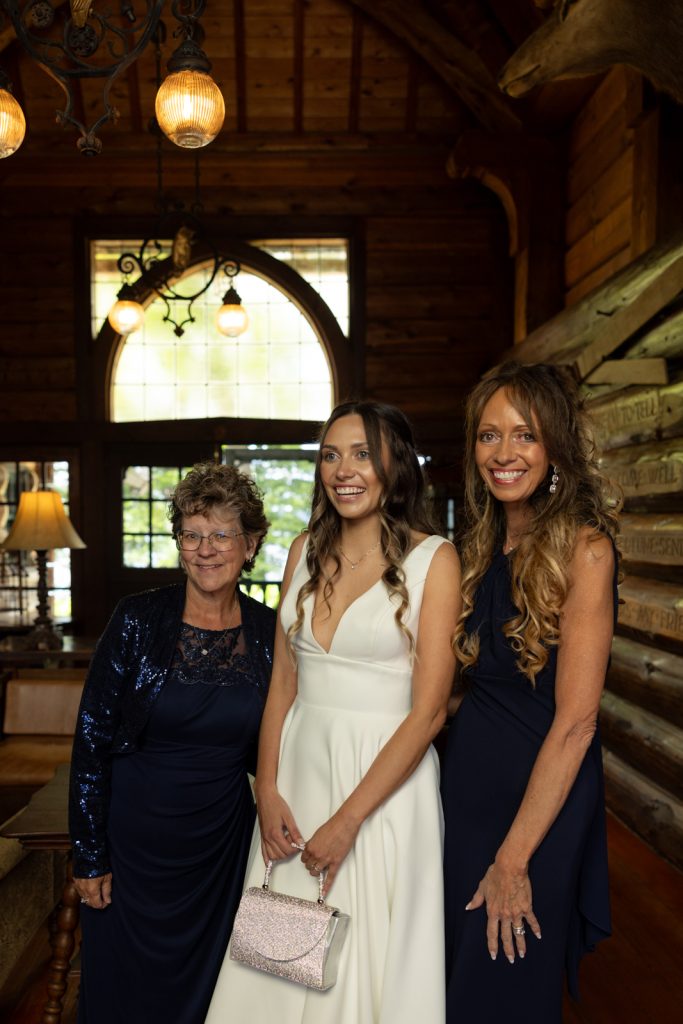Brittany in wedding dress with family at Stout’s Island Lodge, Wisconsin wedding photography.