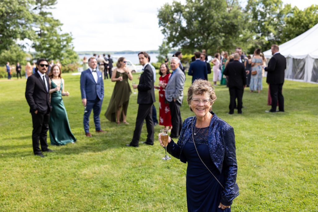 Stout’s Island wedding reception on Red Cedar Lake, Wisconsin, with guests and a smiling woman