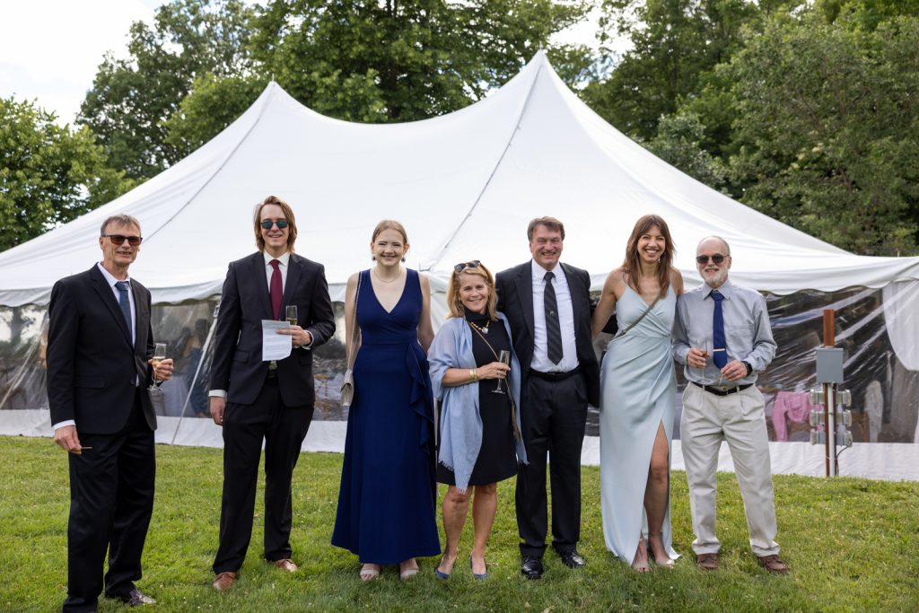Group portrait at Stout’s Island wedding reception under a white tent.