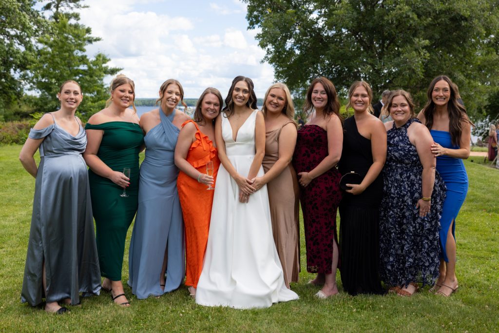 Brittany and Cole’s Stout’s Island wedding party posing on the lawn and lakeside.
