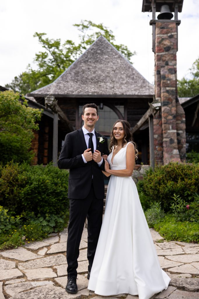 Brittany and Cole, the happy couple, posing at Stout’s Island wedding venue in Birchwood, Wisconsin.