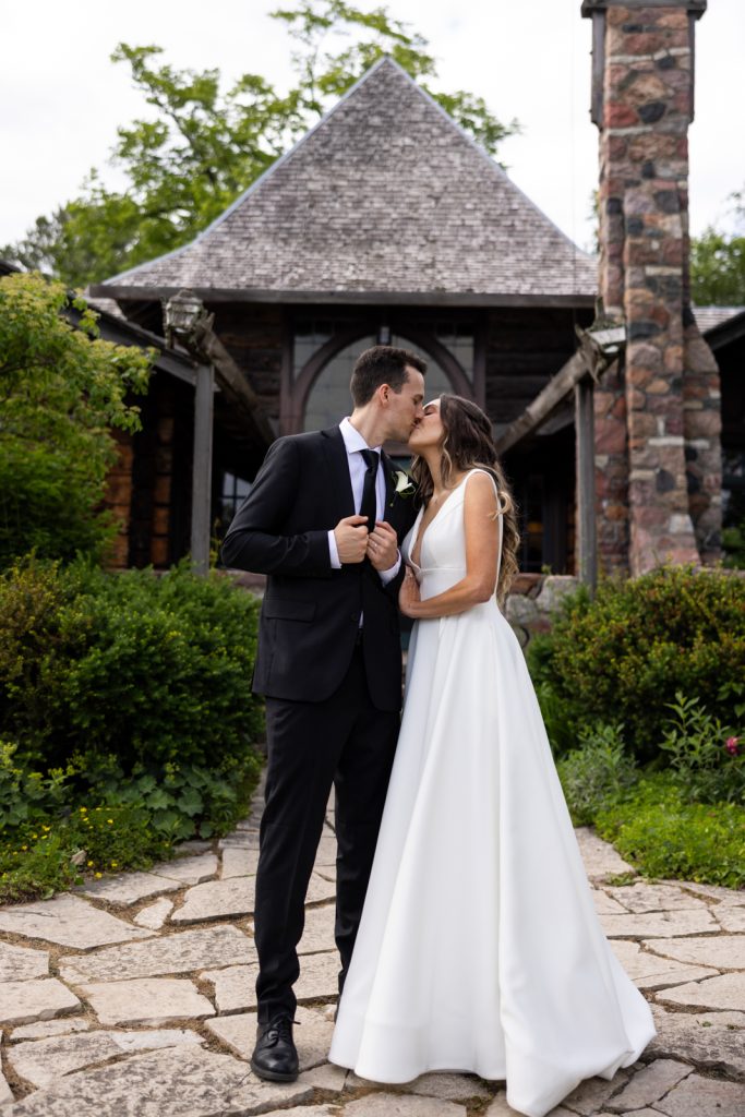 Brittany and Cole kissing at Stout’s Island Lodge wedding in Birchwood, Wisconsin.