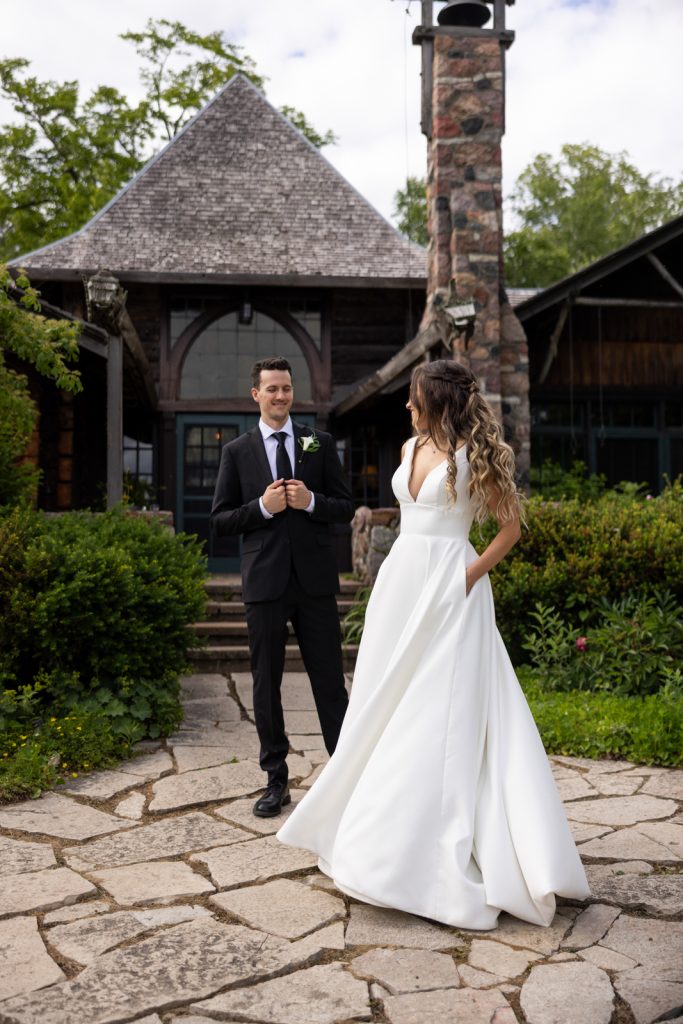 Brittany and Cole, wedding couple, in front of Stout’s Island Lodge boathouse, Wisconsin wedding photography.