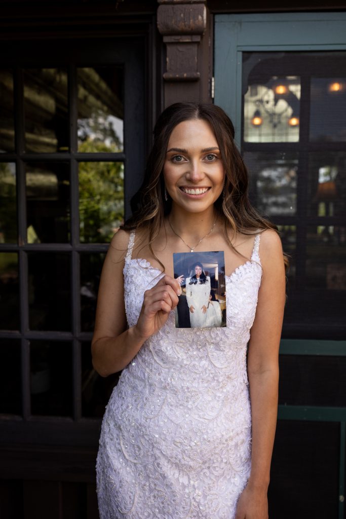 Brittany, Stout’s Island wedding bride holding photo of couple and lake view