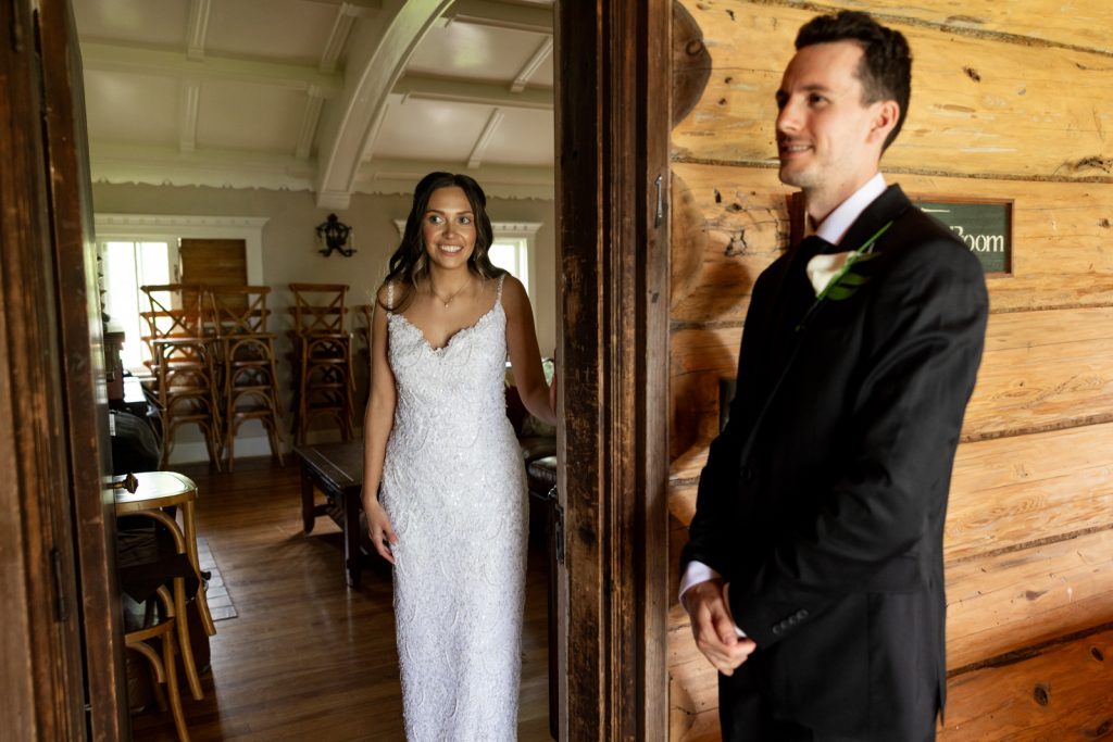 Brittany in wedding dress and Cole in suit, first look moment at Stout’s Island wedding