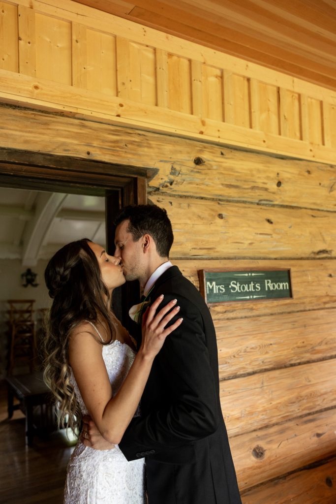 Brittany and Cole kissing in Mrs. Stout's Room at Stout’s Island Lodge wedding venue.